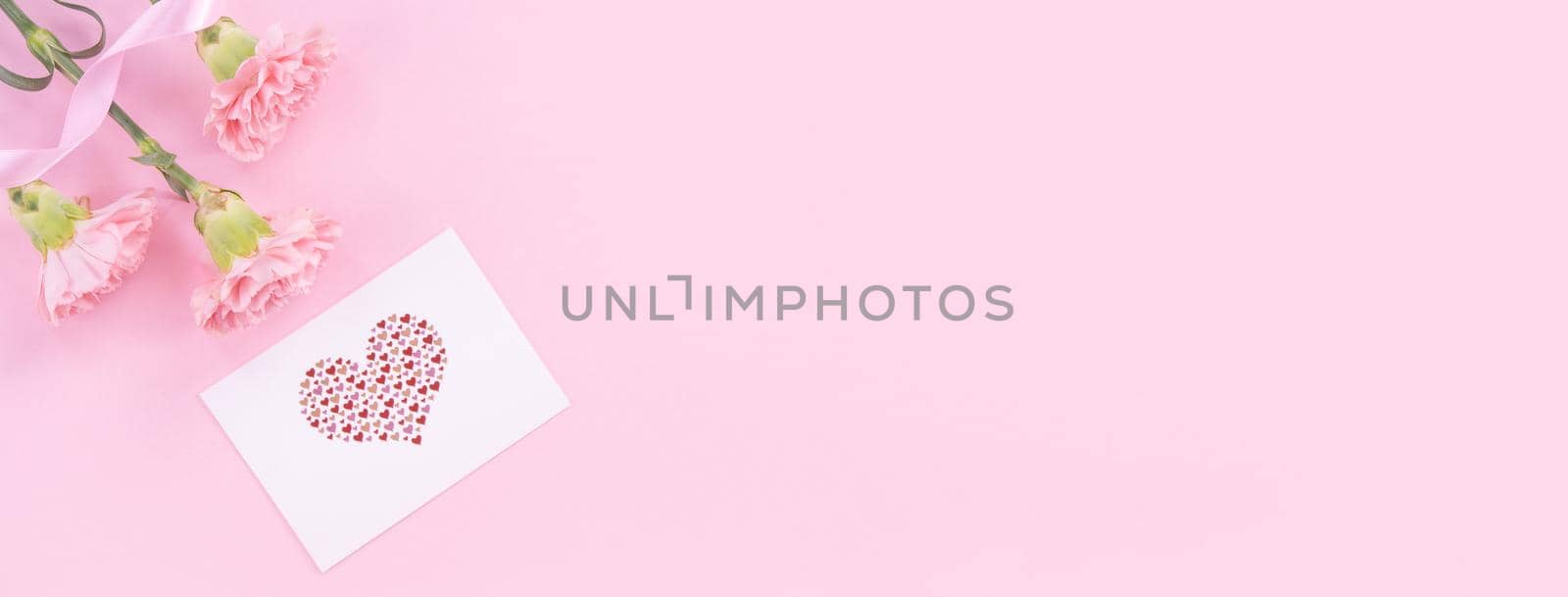 Beautiful, fresh elegant carnation flower bouquet with white greeting thanks gift card isolated on bright pink color background, top view, flat lay concept. by ROMIXIMAGE