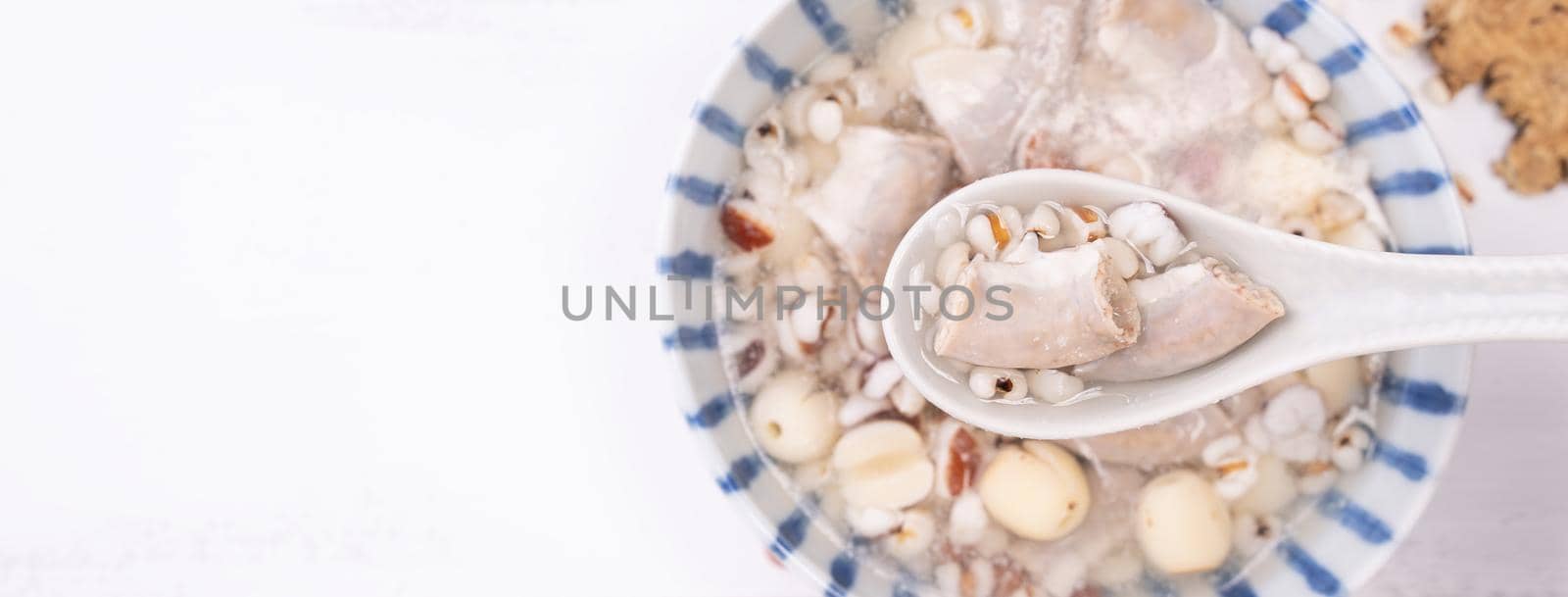 Tasty Four Tonics Herb Flavor Soup, Taiwanese traditional food with herbs, pork intestines on white wooden table, close up, flat lay, top view. by ROMIXIMAGE