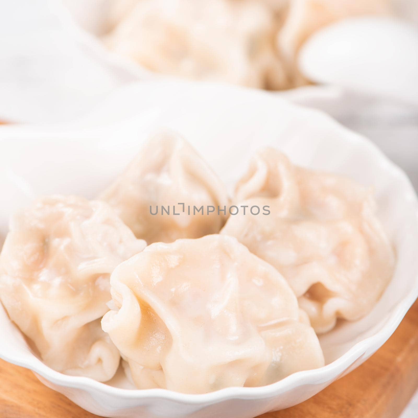 Fresh, delicious boiled pork, shrimp gyoza dumplings on white background with soy sauce and chopsticks, close up, lifestyle. Homemade design concept. by ROMIXIMAGE