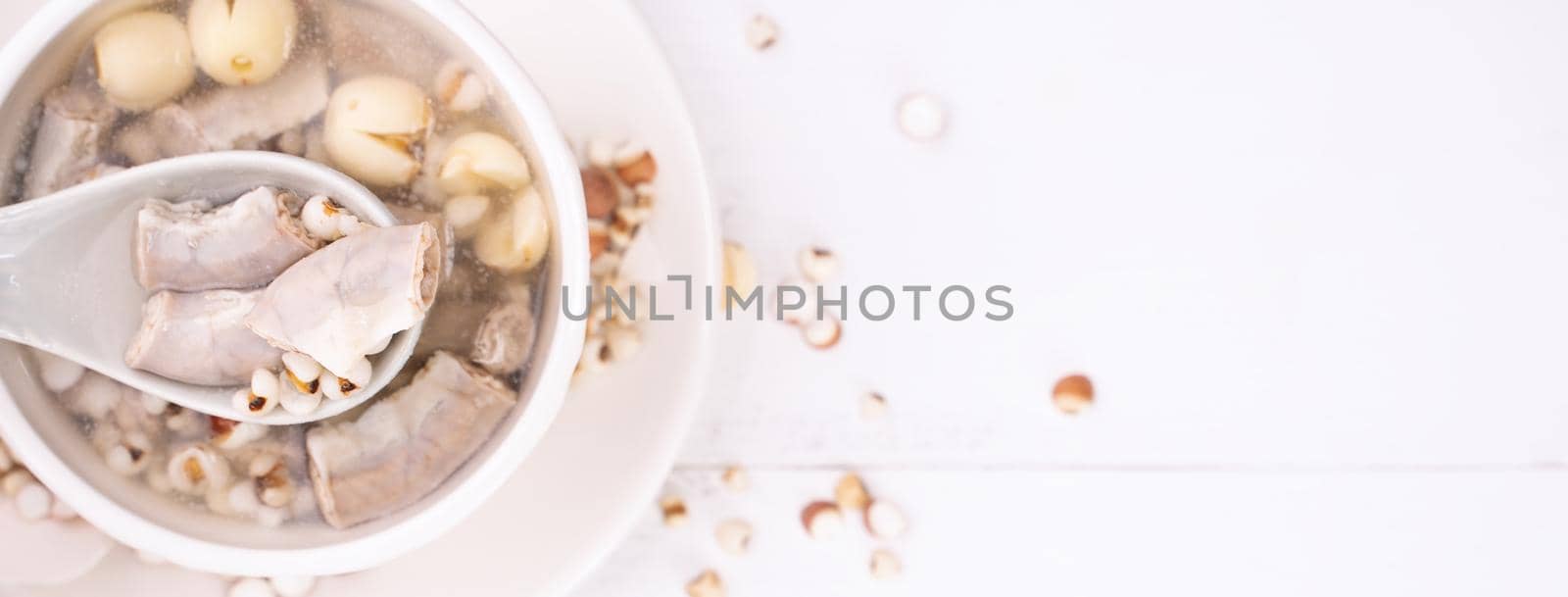 Tasty Four Tonics Herb Flavor Soup, Taiwanese traditional food with herbs, pork intestines on white wooden table, close up, flat lay, top view. by ROMIXIMAGE