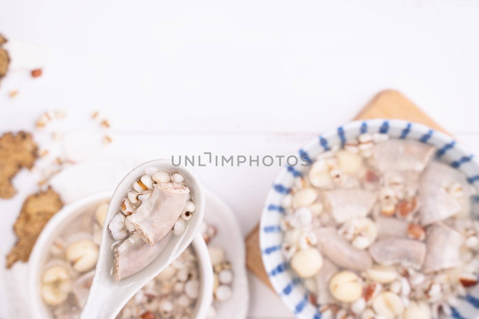 Tasty Four Tonics Herb Flavor Soup, Taiwanese traditional food with herbs, pork intestines on white wooden table, close up, flat lay, top view.