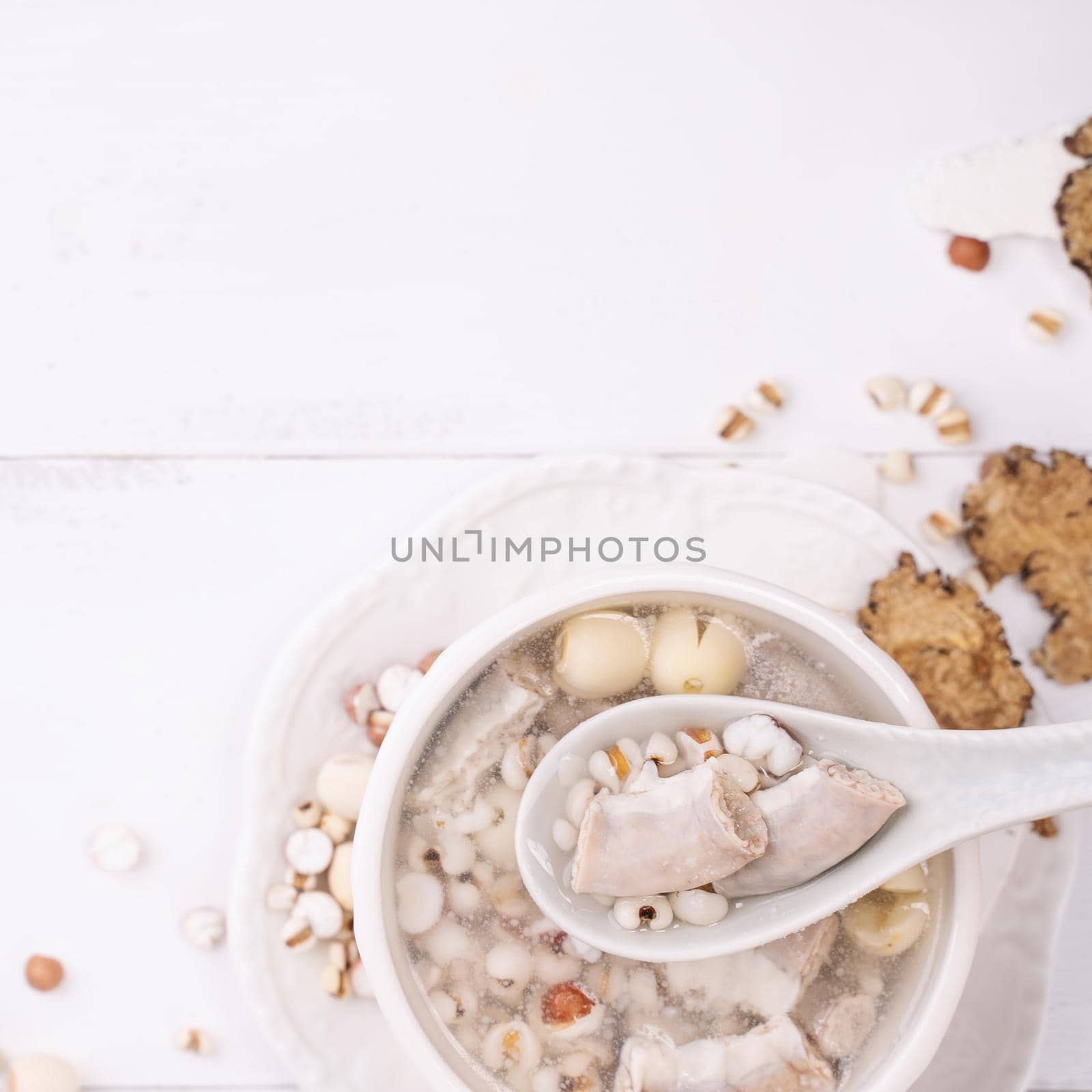Tasty Four Tonics Herb Flavor Soup, Taiwanese traditional food with herbs, pork intestines on white wooden table, close up, flat lay, top view.