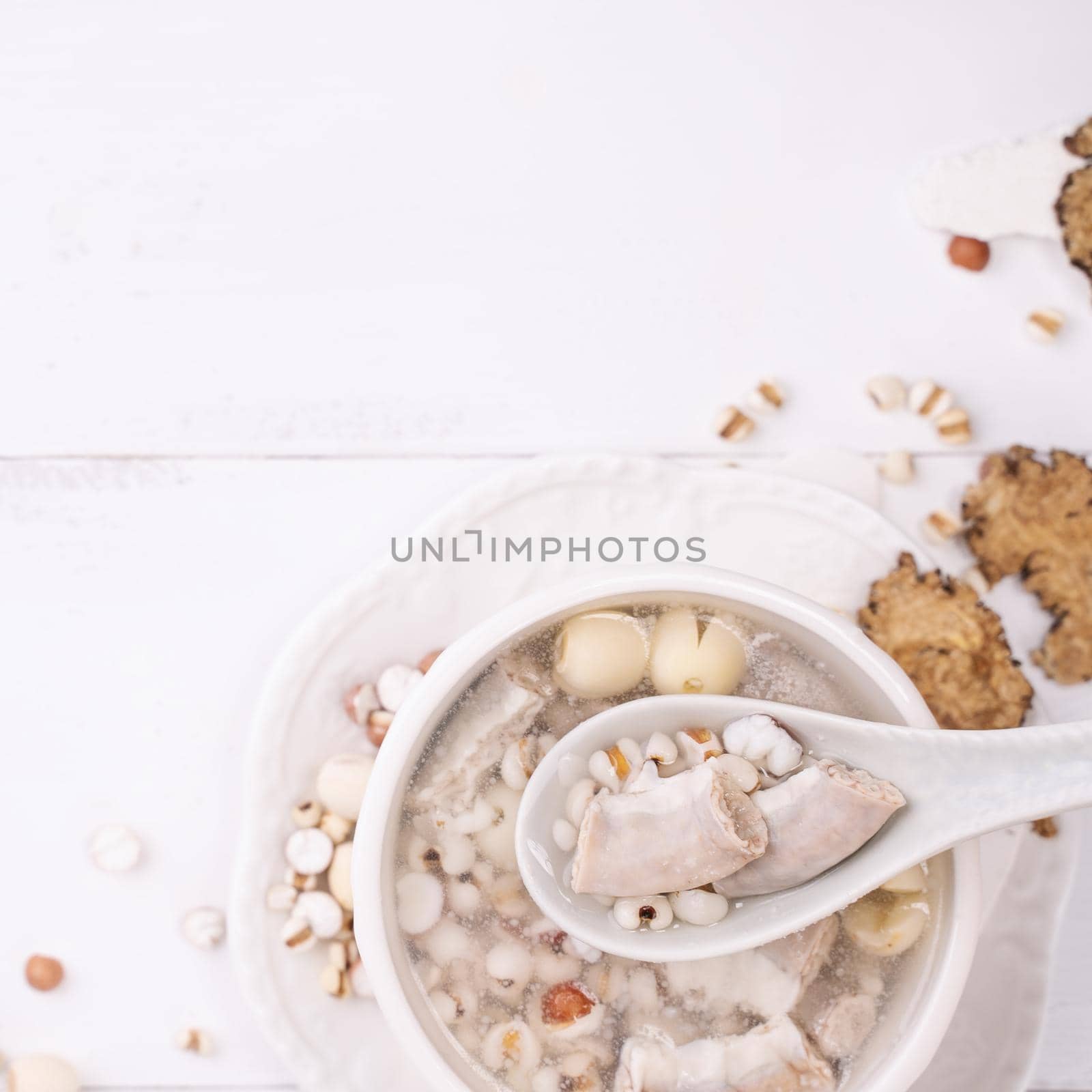 Tasty Four Tonics Herb Flavor Soup, Taiwanese traditional food with herbs, pork intestines on white wooden table, close up, flat lay, top view. by ROMIXIMAGE