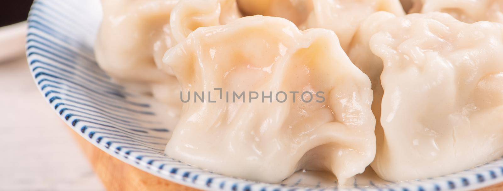 Fresh, delicious boiled pork gyoza dumplings, jiaozi on white background with soy sauce and chopsticks, close up, lifestyle. Homemade design concept. by ROMIXIMAGE