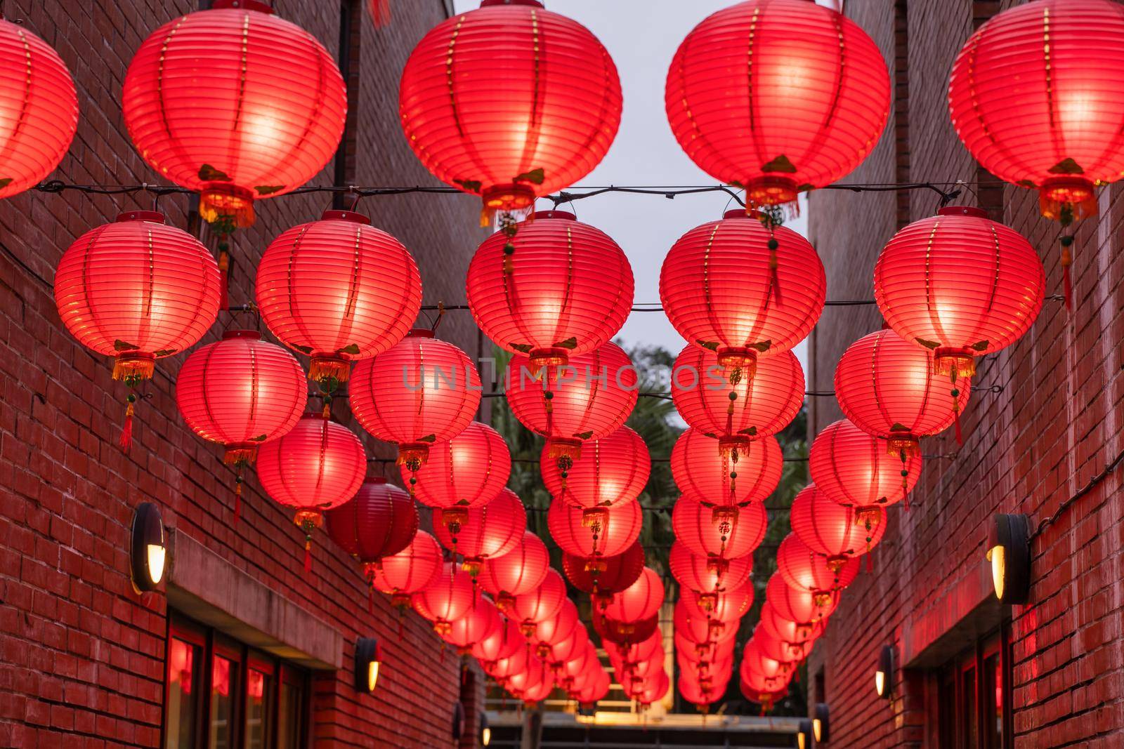 Beautiful round red lantern hanging on old traditional street, concept of Chinese lunar new year festival, close up. The undering word means blessing.