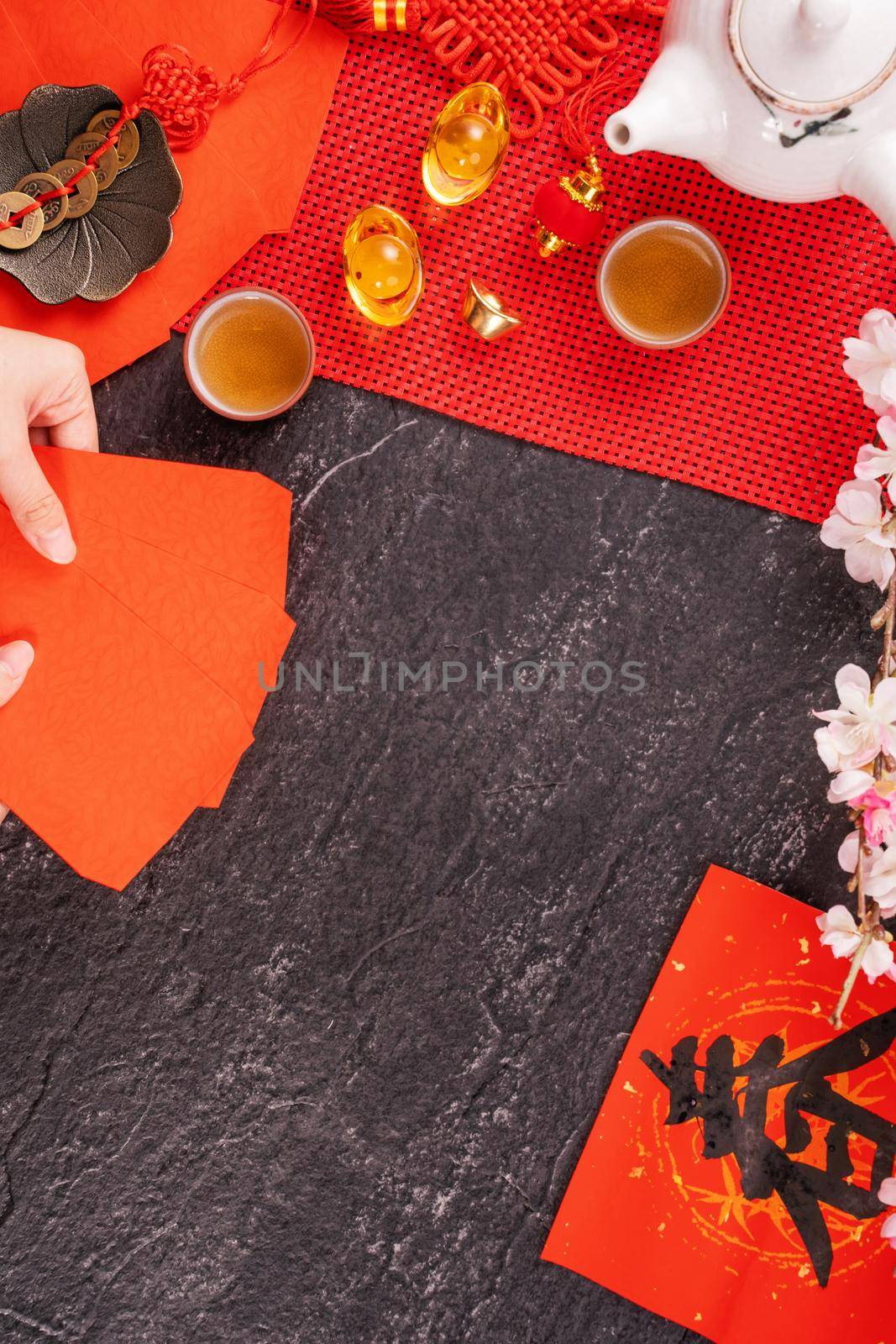 Design concept of Chinese lunar January new year - Woman holding, giving red envelopes (ang pow, hong bao) for lucky money, top view, flat lay, overhead above. The word 'chun' means coming spring.