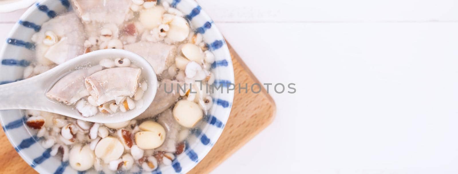 Tasty Four Tonics Herb Flavor Soup,Taiwanese traditional food with herbs,pork intestines on white wooden table,close up,flat lay,top view