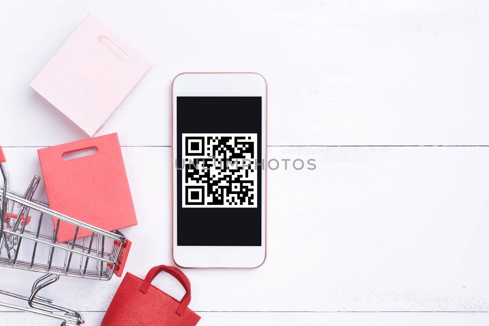 Abstract online shopping, mobile payment with QR code design concept element, colorful cart, paper bag on wooden table background, top view, flat lay