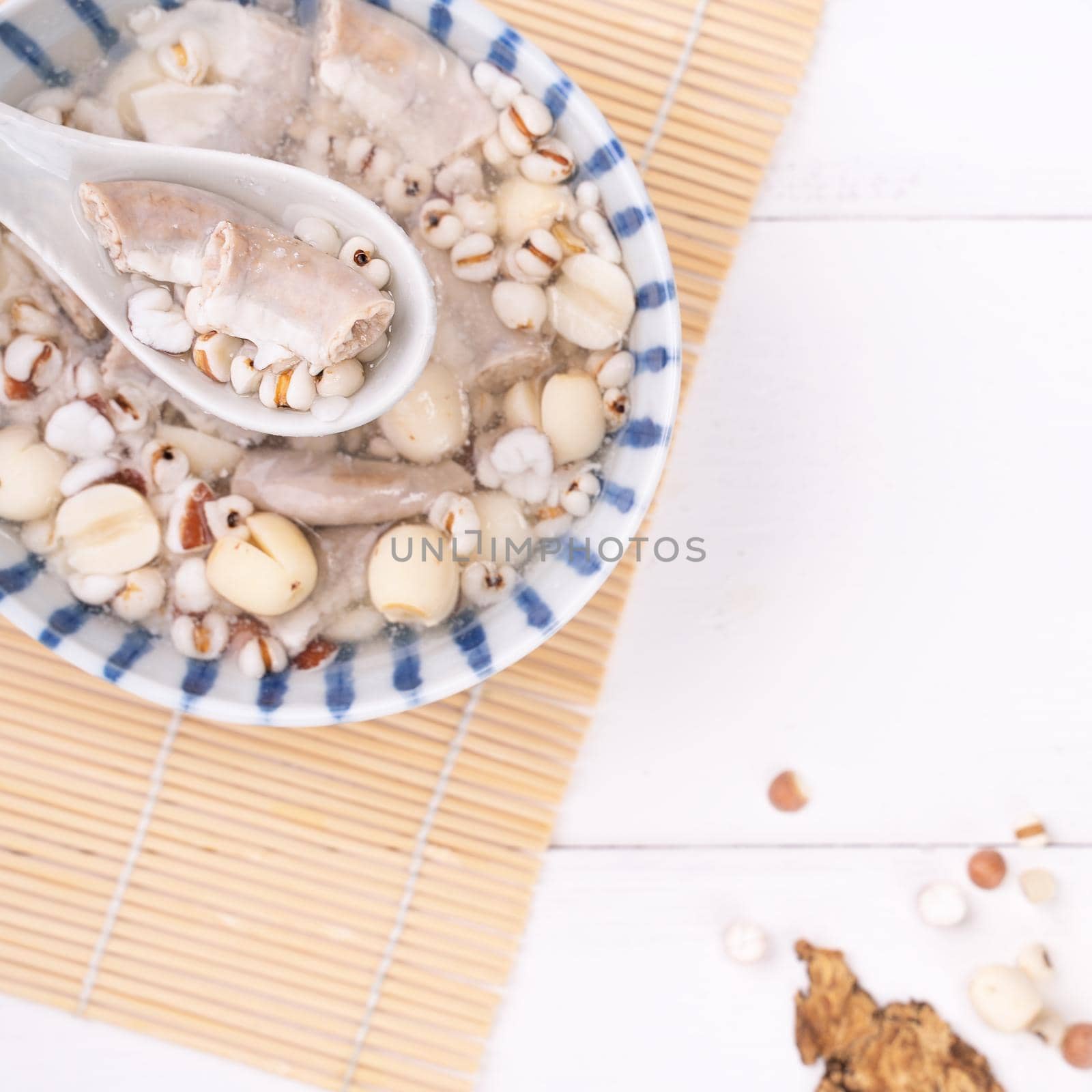 Tasty Four Tonics Herb Flavor Soup, Taiwanese traditional food with herbs, pork intestines on white wooden table, close up, flat lay, top view.