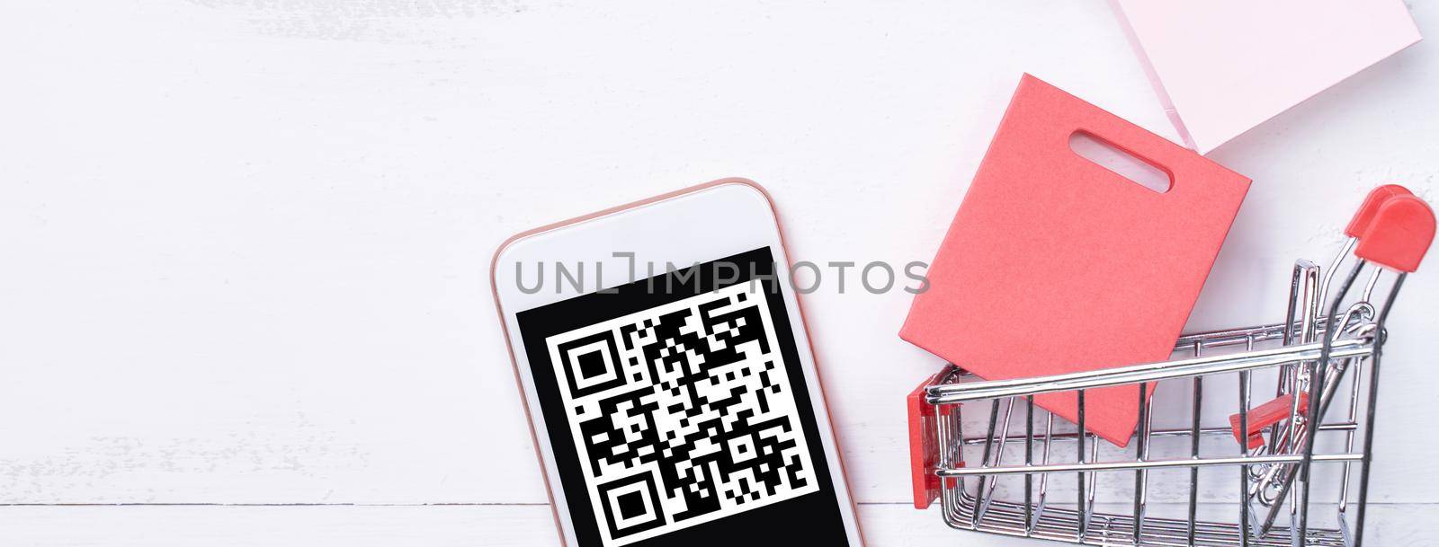 Abstract online shopping, mobile payment with QR code design concept element, colorful cart, paper bag on wooden table background, top view, flat lay