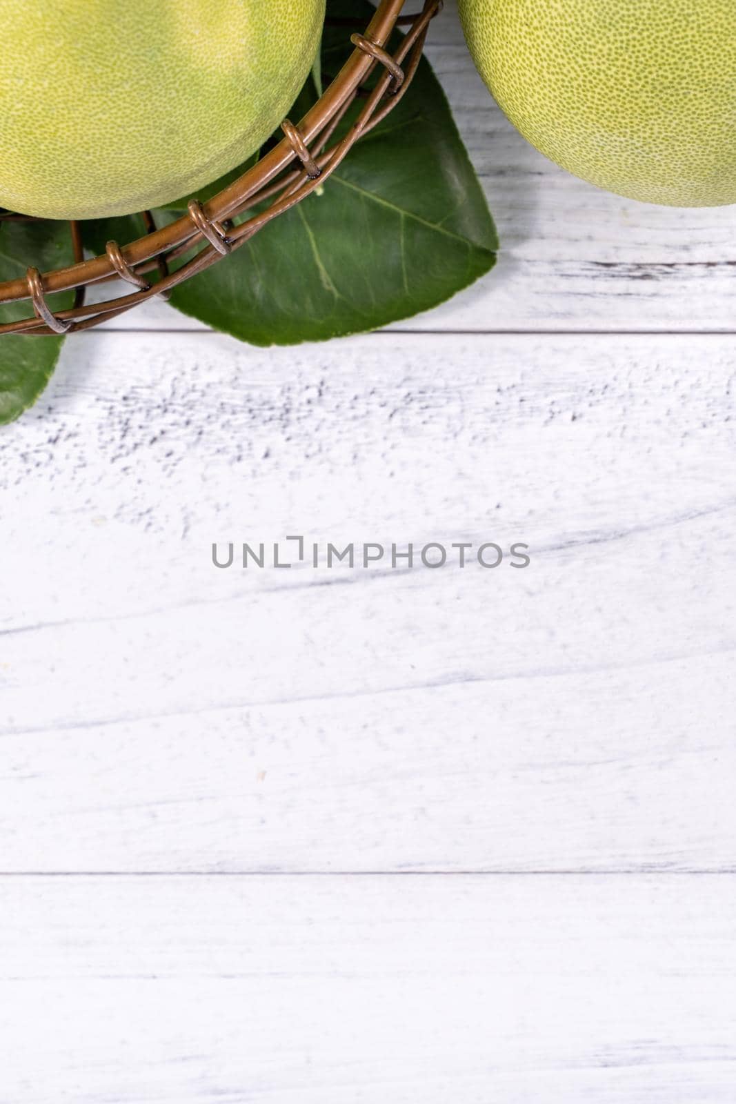 Fresh peeled pomelo, pummelo, grapefruit, shaddock on bright wooden background. Autumn seasonal fruit, top view, flat lay, tabletop shot. by ROMIXIMAGE