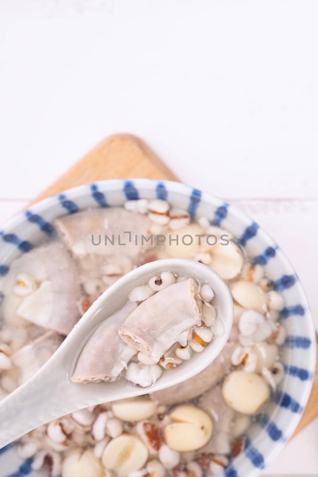 Tasty Four Tonics Herb Flavor Soup, Taiwanese traditional food with herbs, pork intestines on white wooden table, close up, flat lay, top view.