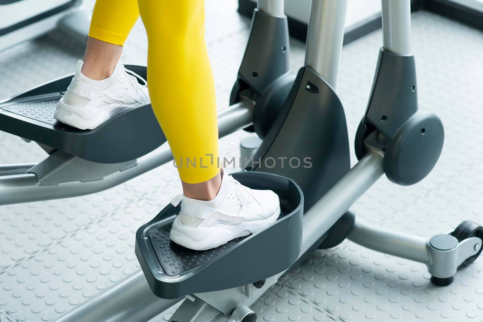 Gym: Woman Working Out On Elliptical Machine