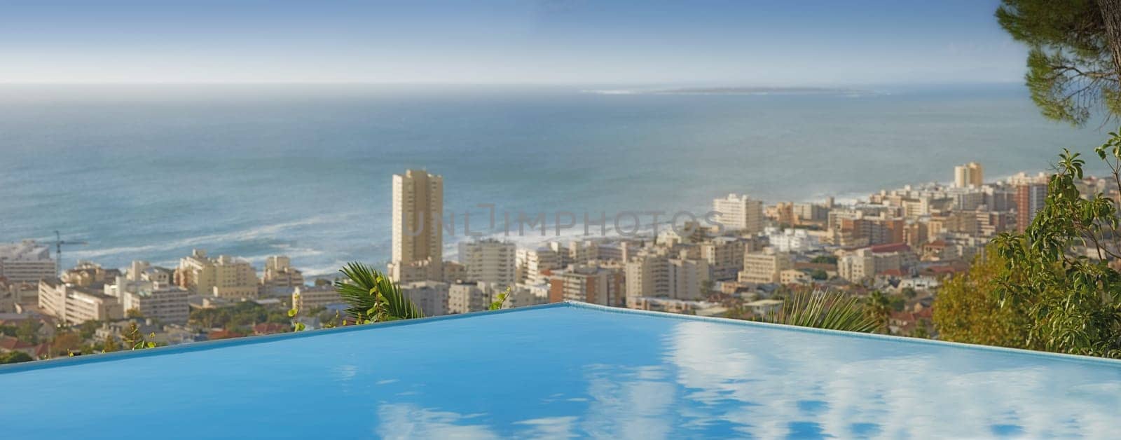 Travel, ocean and infinity pool in city on vacation and hotel view in Cape Town with nobody, buildings and urban beach property. Cityscape, sea and sky at luxury accommodation for summer holiday trip.