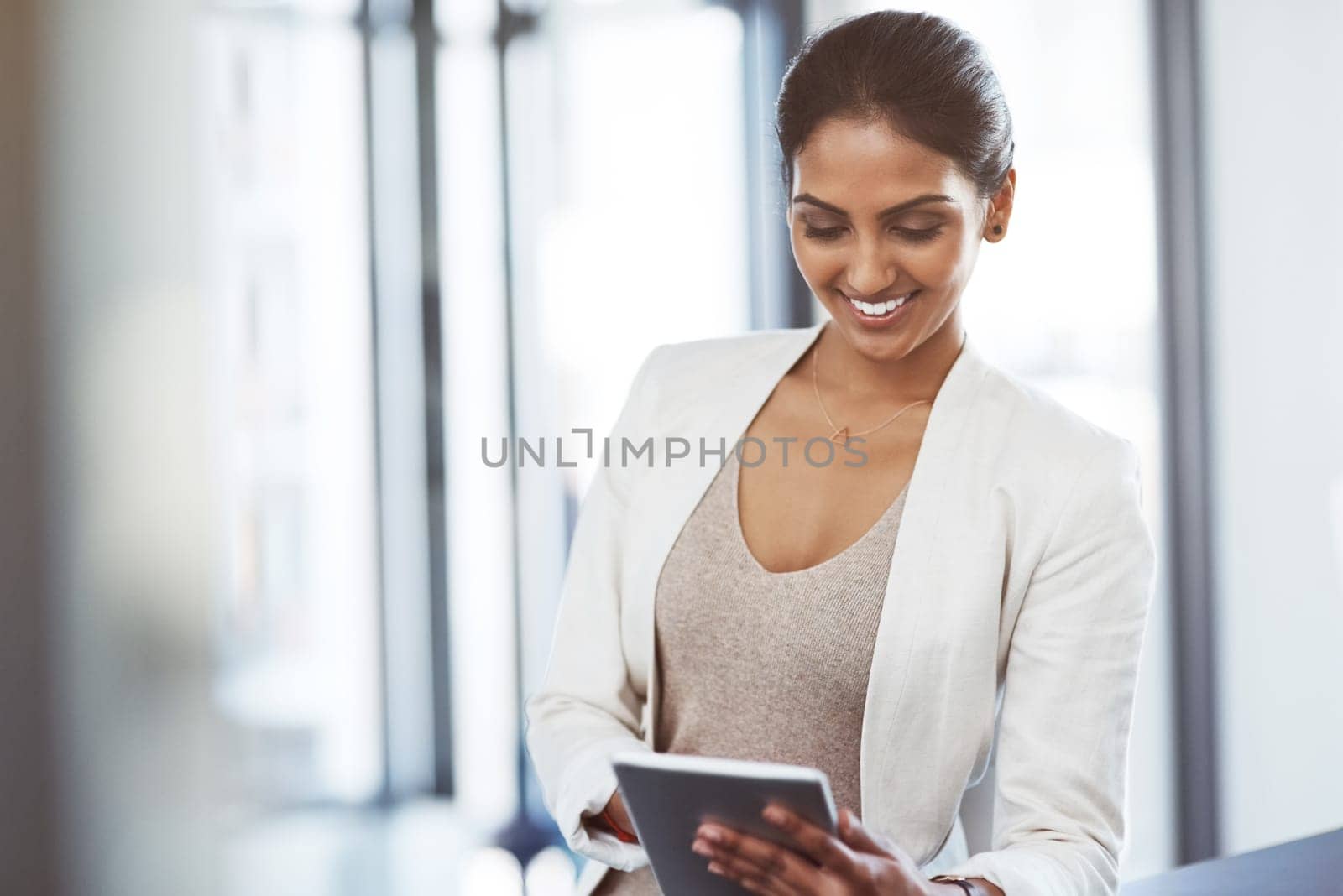Smart professionals use smart technology. a young businesswoman using a digital tablet at work