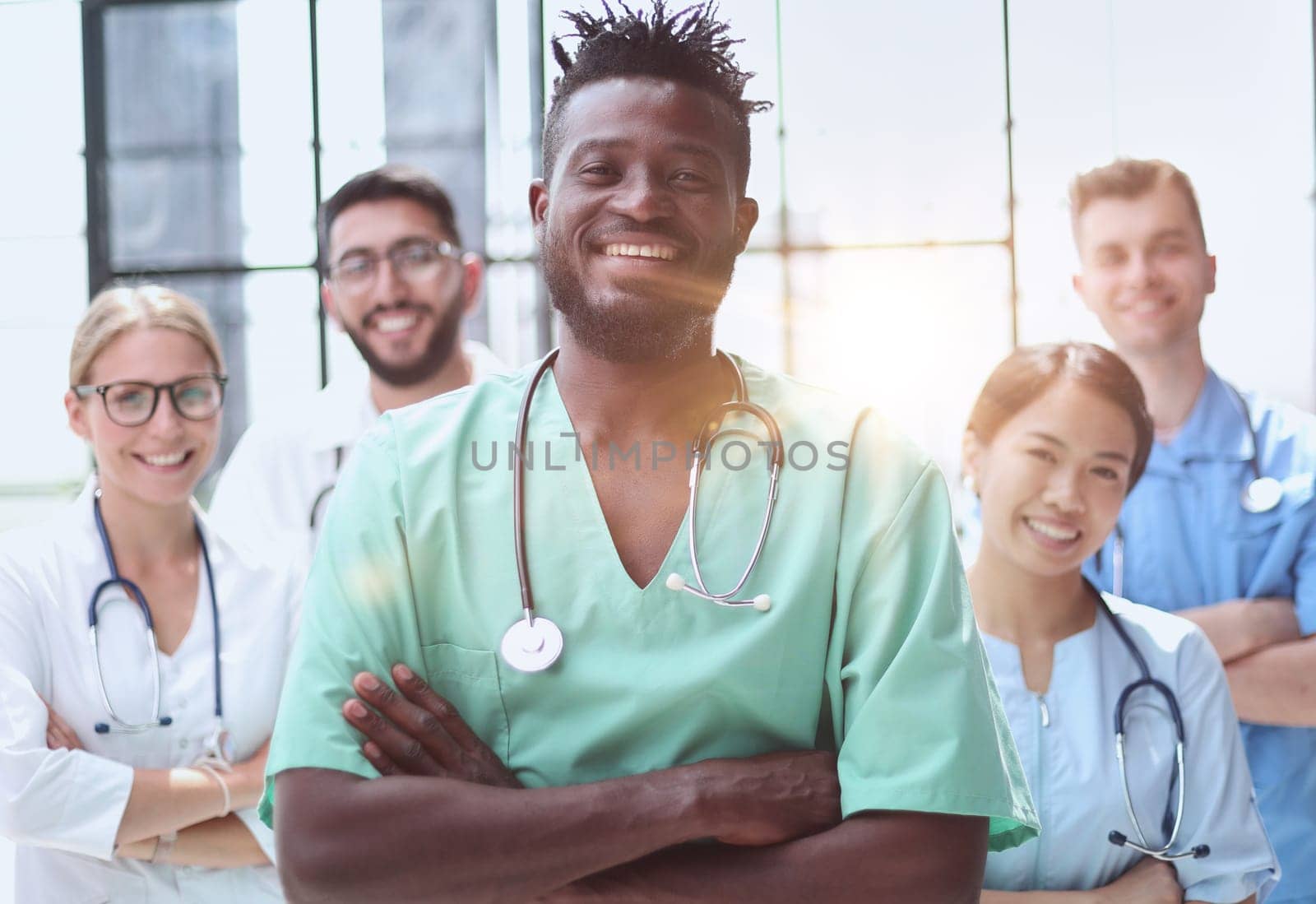 Smiling group of scientists in modern laboratory with male african american leader, mix race by Prosto