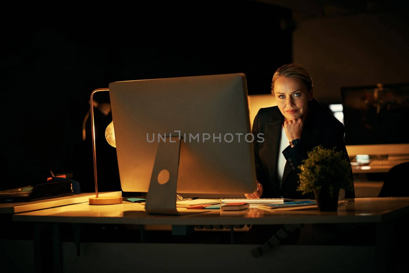 I do whatever it takes to achieve my goals. a mature businesswoman working late at the office