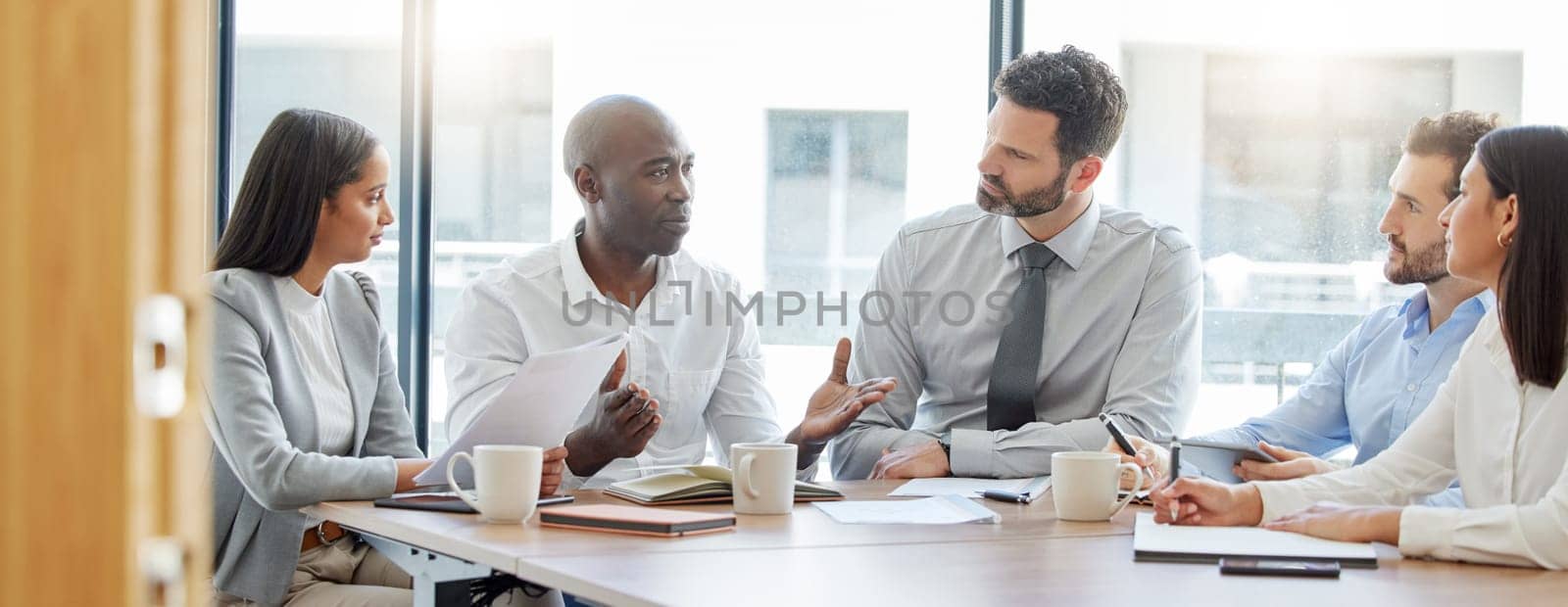 Collaboration, teamwork or business people in meeting for project management or speaking of a strategy. Black man, corporate or employees talking in discussion with our vision for growth in office by YuriArcurs