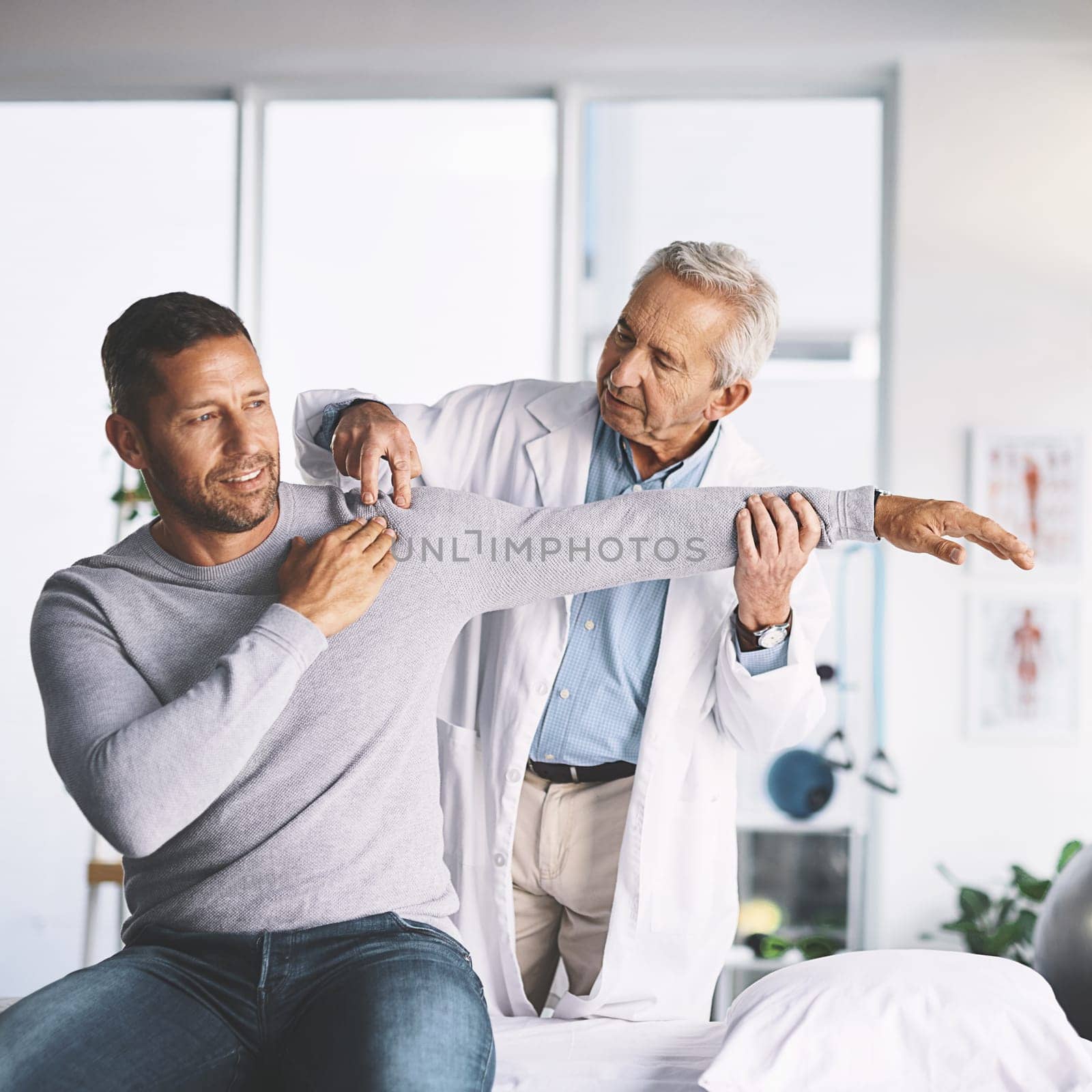 How does this feel. a senior doctor giving his male patient a thorough checkup during his consultation