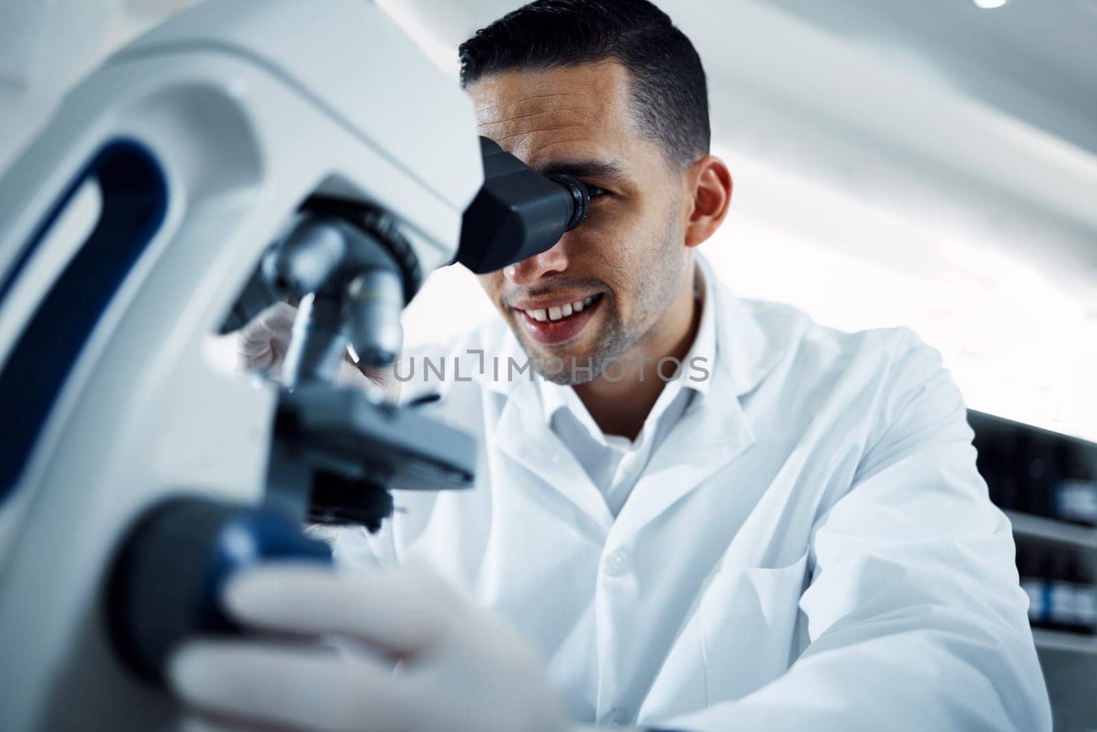 Science, research and man with microscope in laboratory for medical analysis, innovation and dna test. Healthcare, biotechnology and male scientist with equipment for study, virus sample and medicine.