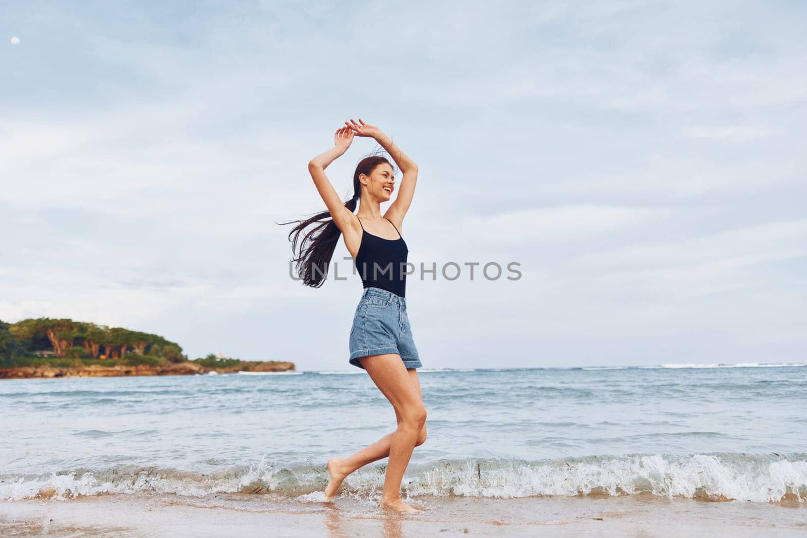 active woman beautiful sea shore summer girl freedom carefree relax sun leisure sunset running beach sexy travel smile lifestyle young smiling