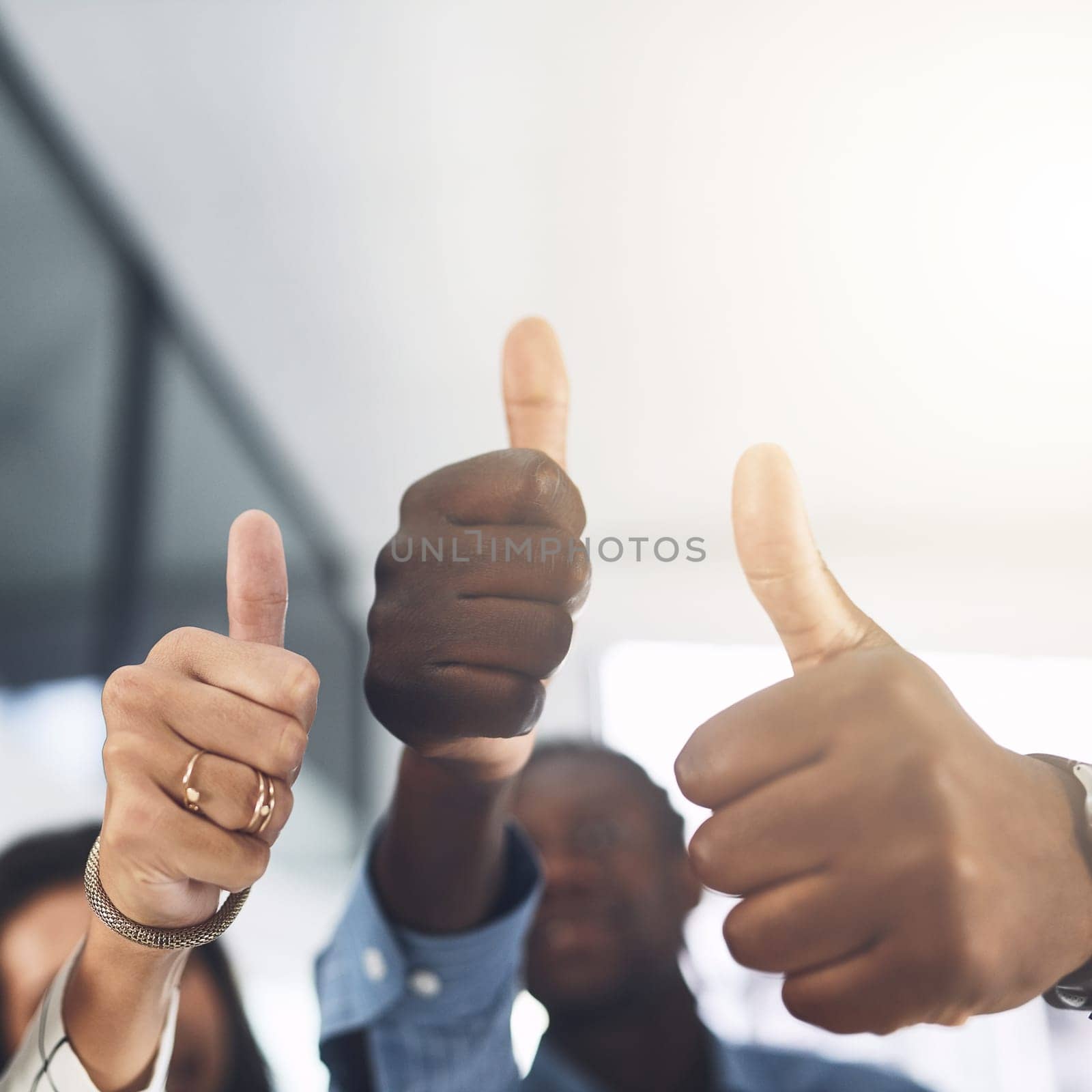 We hope you succeed big. Closeup shot of a group of businesspeople showing thumbs up in an office. by YuriArcurs