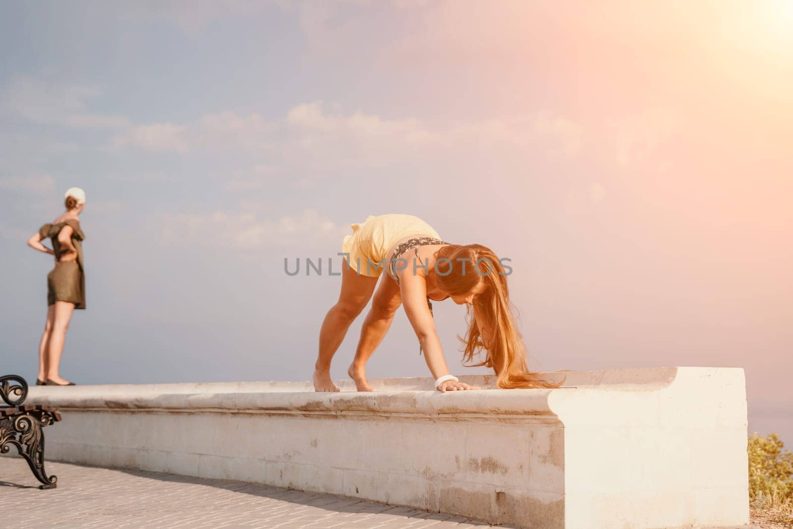 Woman park yoga. Side view of free calm bliss satisfied woman with long hair standing in morning park with yoga position against of sky by the sea. Healthy lifestyle outdoors in park, fitness concept