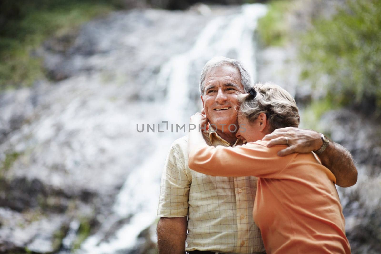 Nature, love and senior couple hug, funny or retirement with relationship, romantic or loving together. Outdoor, old woman or elderly man embrace, natural or laughing with support, bonding or romance by YuriArcurs