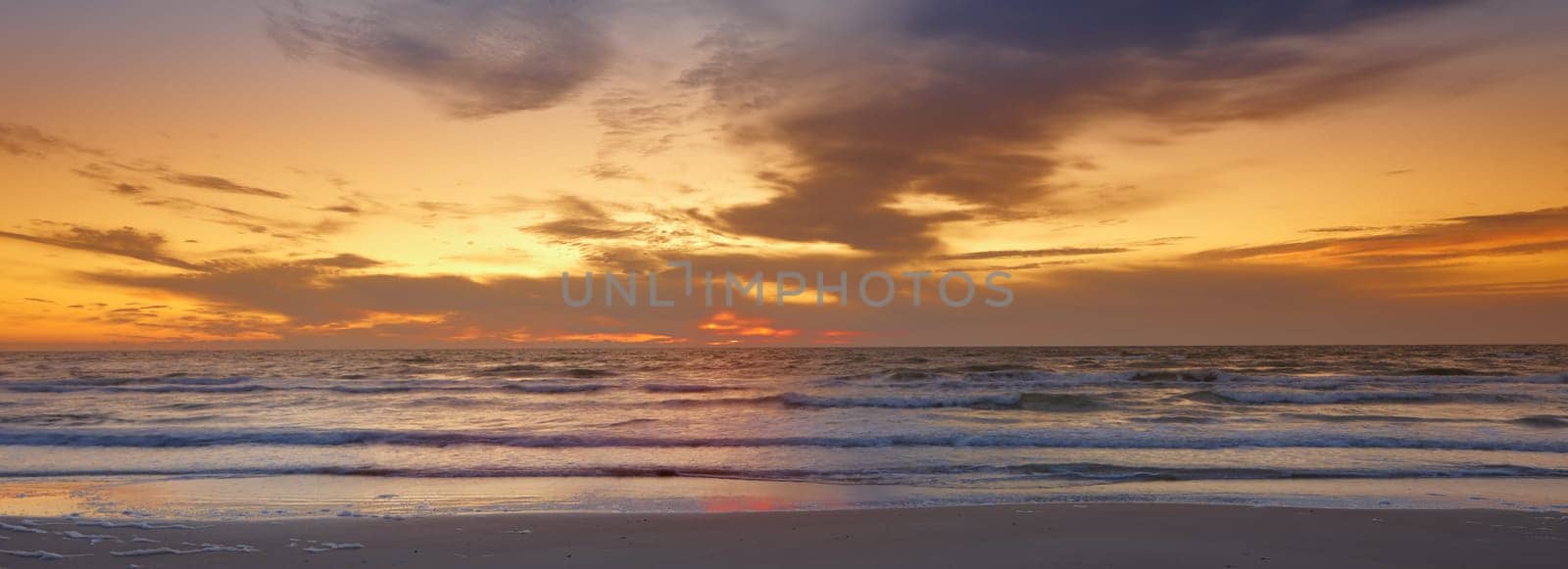 Sky, sunset and sea at morning on the horizon with ocean and waves landscape. Sunrise, calm weather and summer by the beach with coastline and outdoor with the sun setting by water in nature.