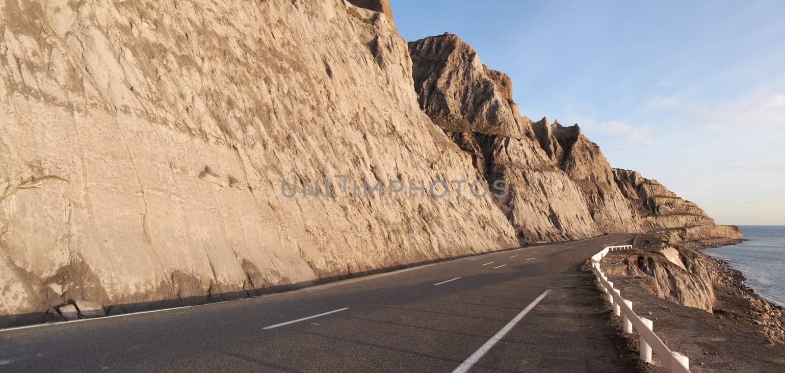 Road, mountain and travel with coastal landscape, direction and destination with asphalt and nature. Environment, street and beach location with journey and traveling view outdoor with horizon.
