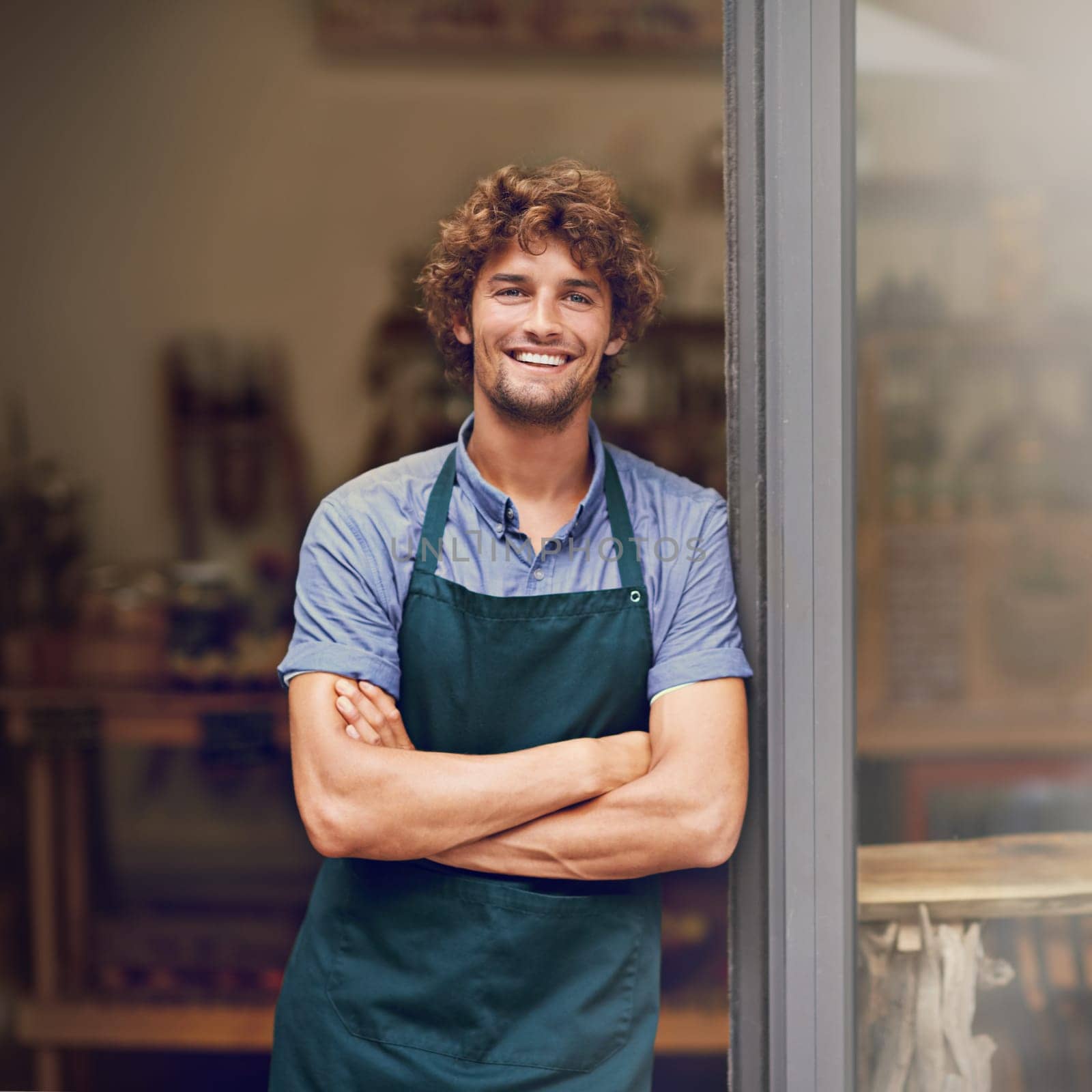 Retail, arms crossed and portrait of man at restaurant for small business, coffee shop and waiter. Entrepreneur, happy and smile with male barista at front door of cafe for diner and food industry by YuriArcurs
