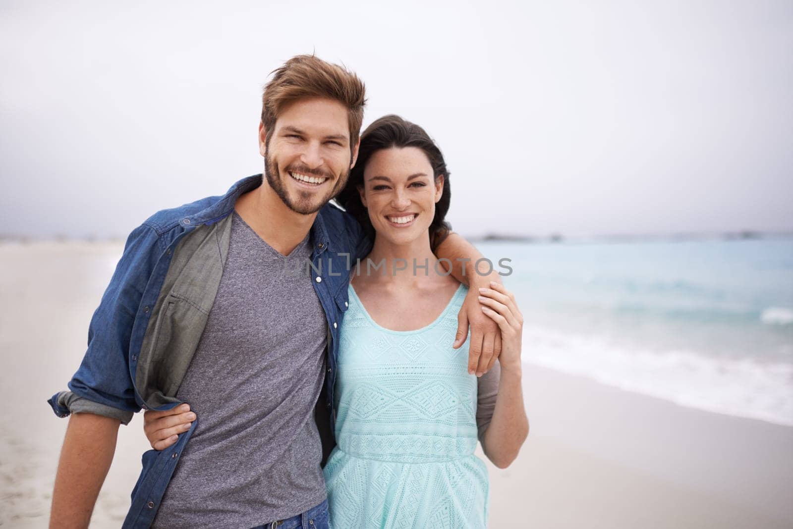 Portrait, couple and hug at beach for travel, romance and freedom while walking together outdoors. Love, face and happy woman embracing man on trip, vacation or holiday, bond or having fun in Florida by YuriArcurs