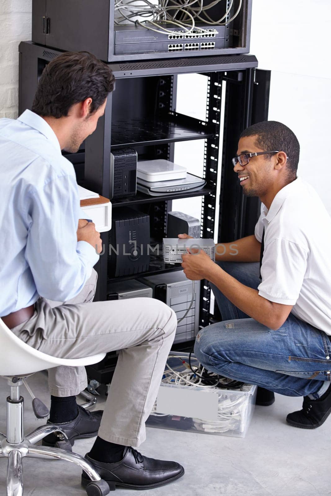 Server room, it support and maintenance with an engineer talking to a business man about cyber security. Network, database and consulting with a technician chatting about information technology.