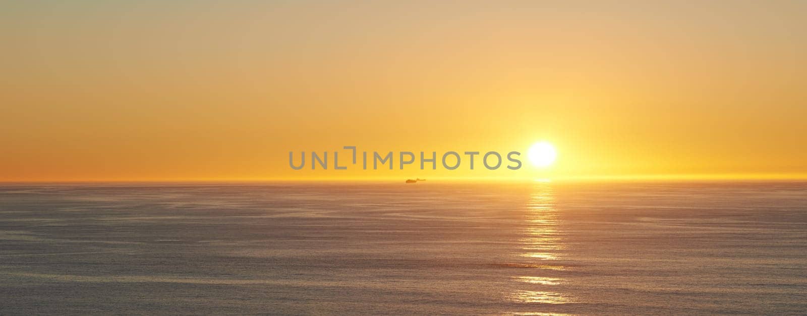 Orange sky, sunset and sea at morning on the horizon with ocean and waves landscape. Sunrise background, calm weather and summer by beach with coastline and outdoor environment with sun and mockup by YuriArcurs