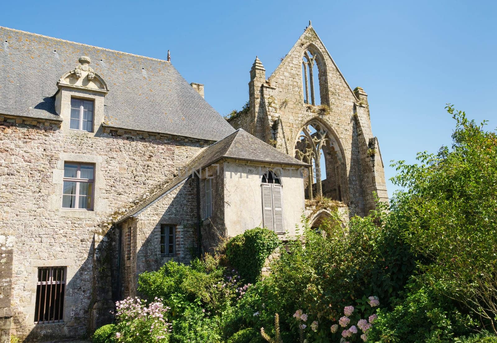 Partial view of the ruins of the Abbey of Beauport in the French commune of Paimpol, with blue sky and sunny day.