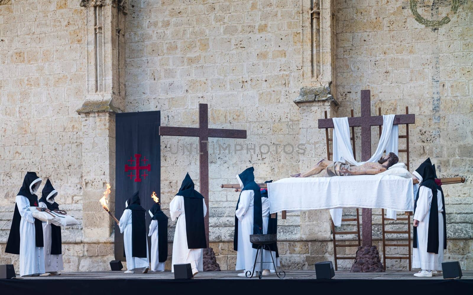 Easter Week in Palencia, Spain. Penitents and monks carrying the image of the dead Jesus Christ.