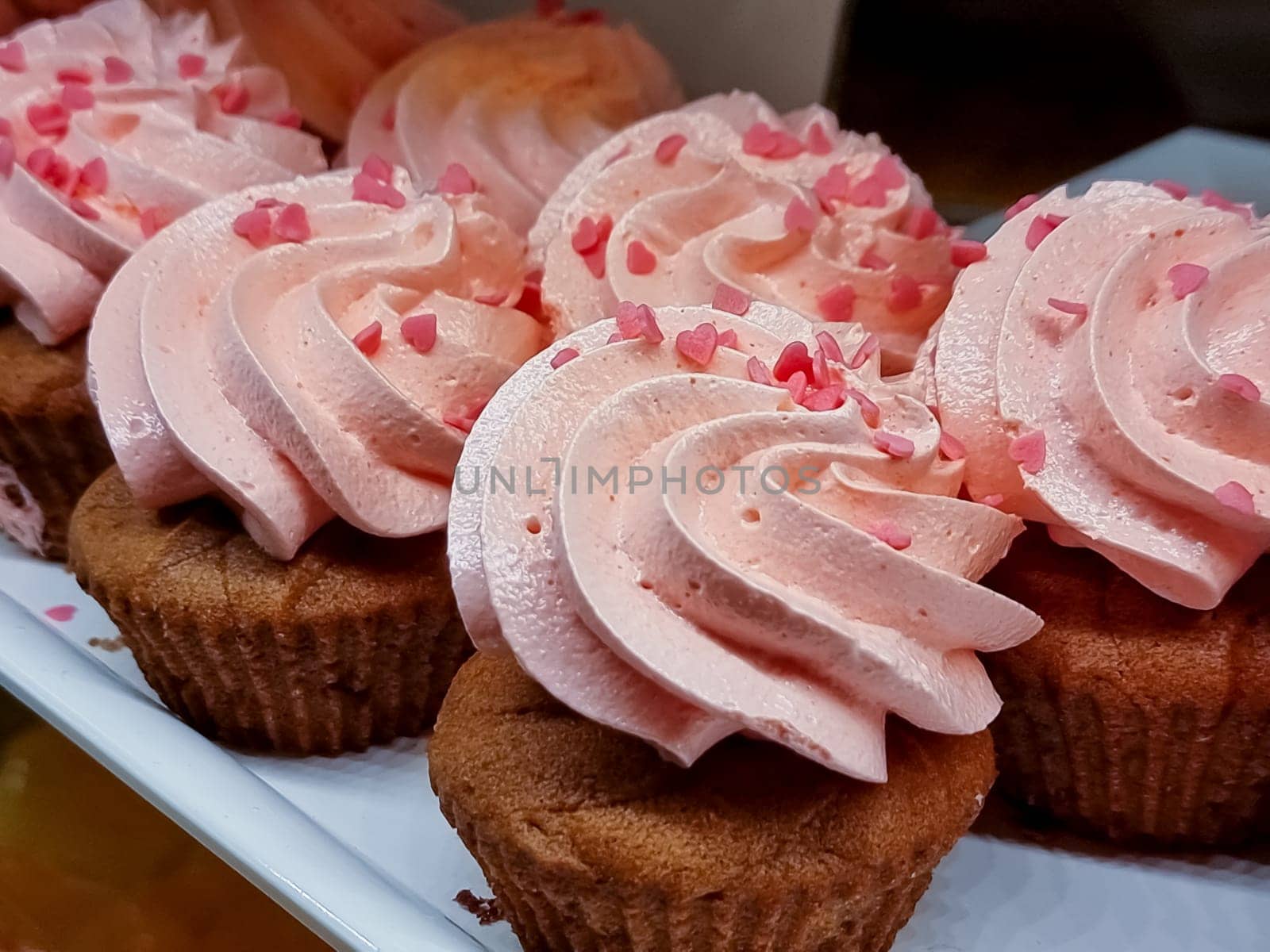 cupcakes with summer berries on blue wooden table