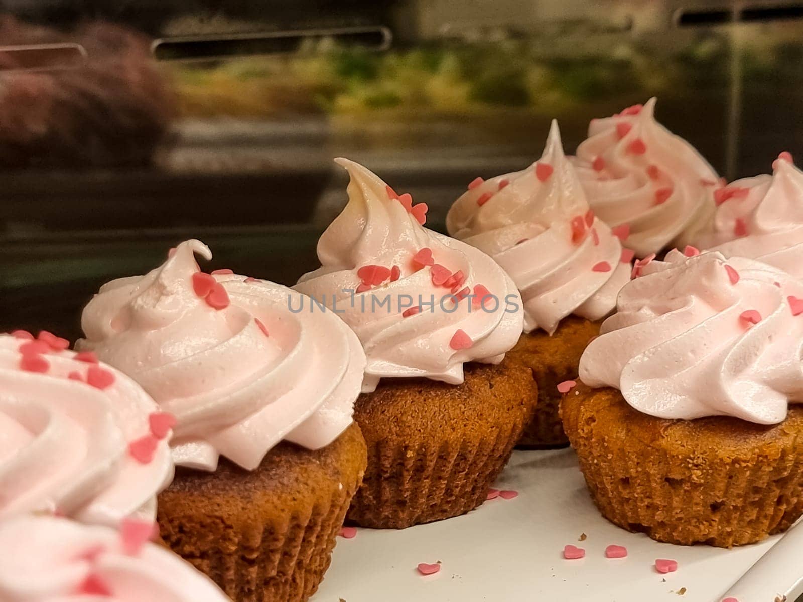 cupcakes with summer berries on blue wooden table