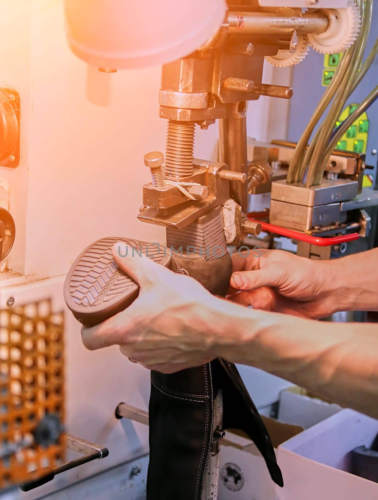 The process of making shoes in a factory. Workshop, assembly line in a shoe factory.