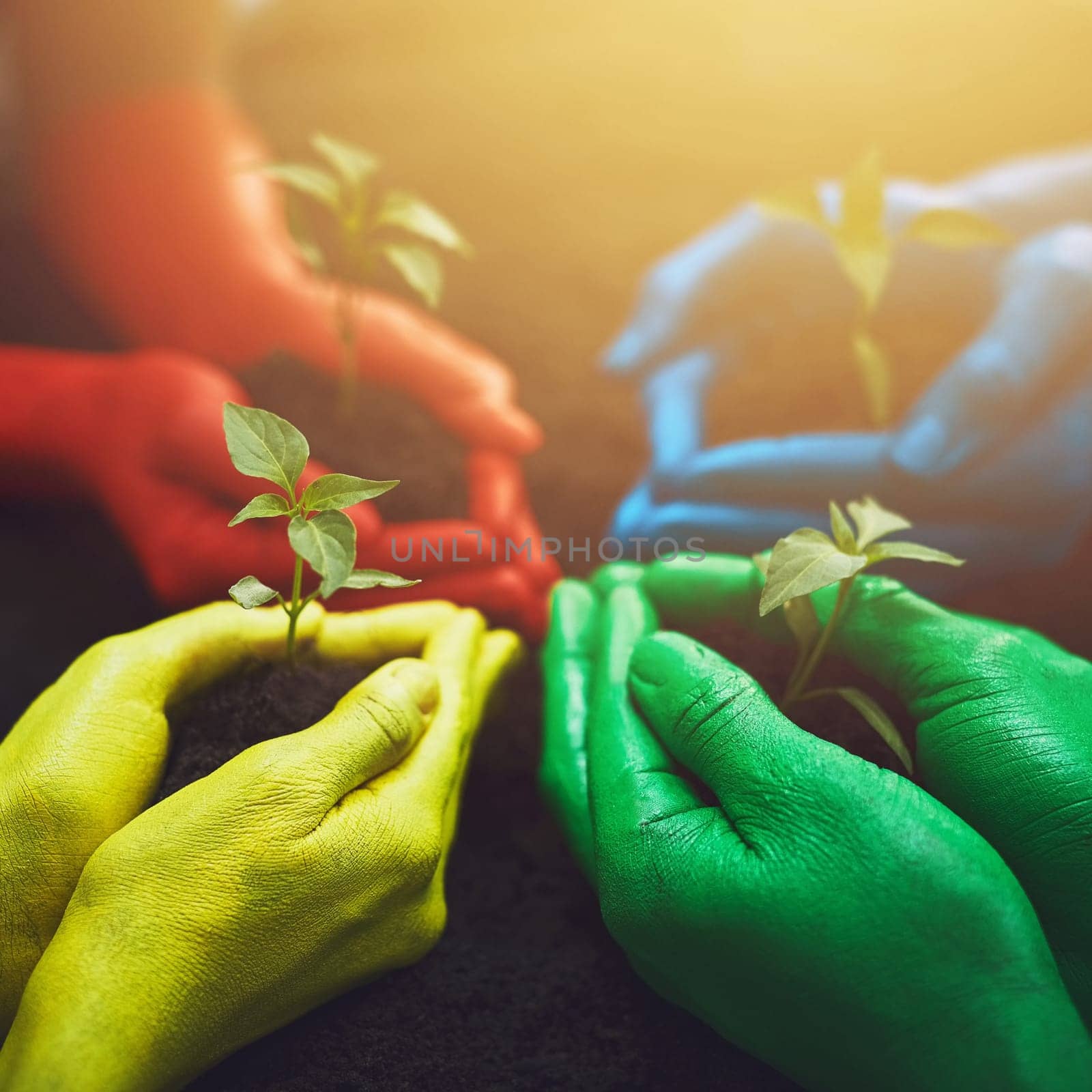 Grow as as high as you can. unrecognizable people holding budding plants in their multi colored hands. by YuriArcurs
