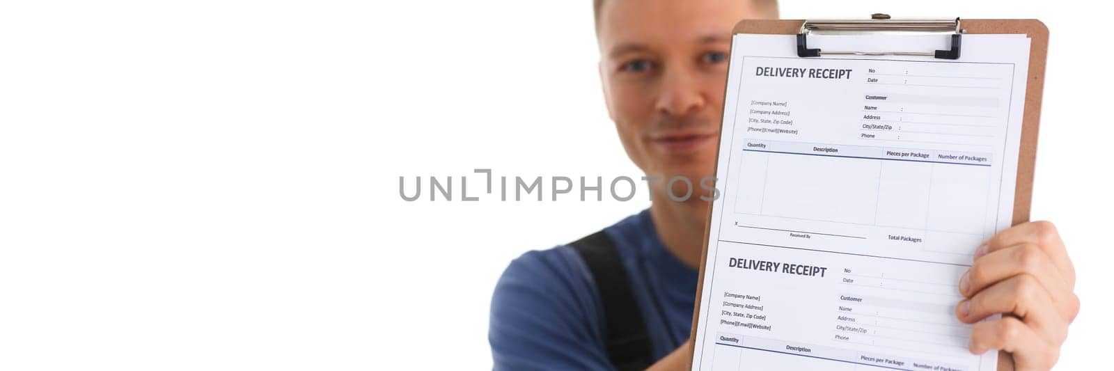 Delivery man holds clipboard with delivery receipt in hands. Courier logistics and delivery of goods concept