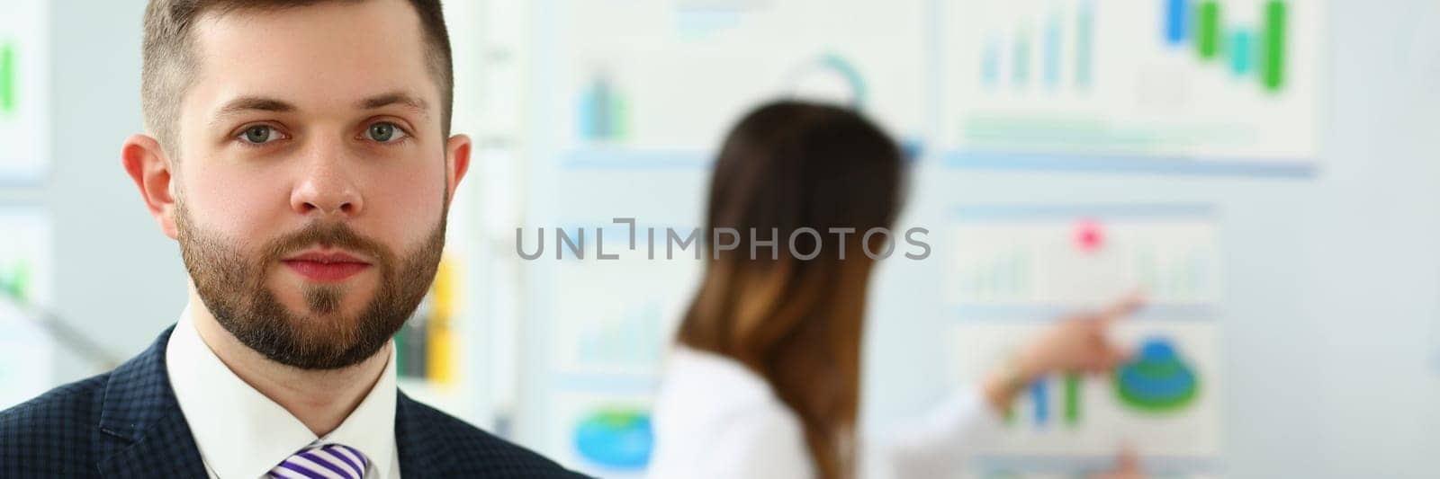 Portrait of handsome businessman consultant coach at marketing conference by kuprevich