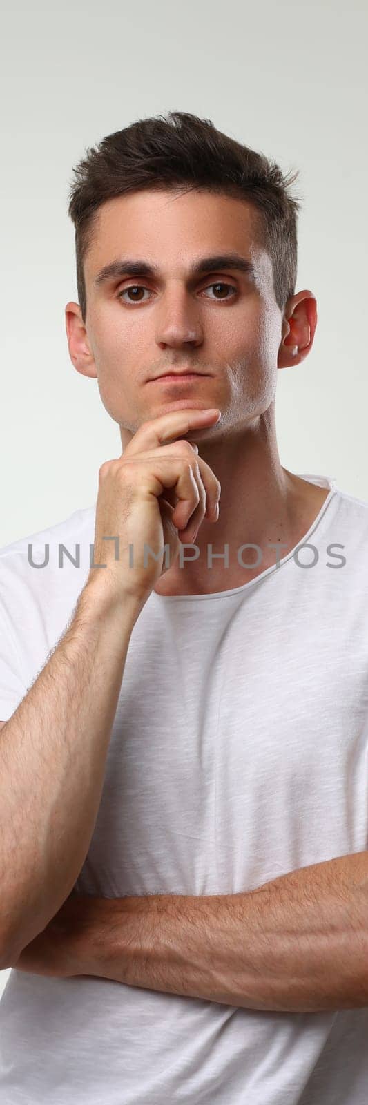 Portrait of young handsome athletic man in white t-shirt by kuprevich