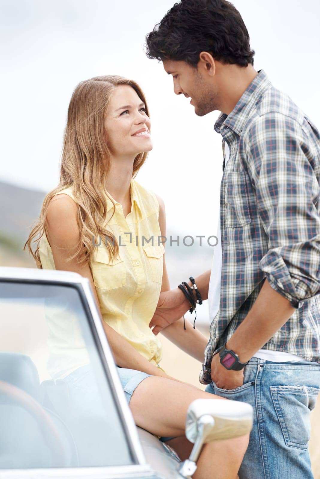 Sharing that special look. A young couple sharing a romantic moment on a hilltop after taking a scenic drive
