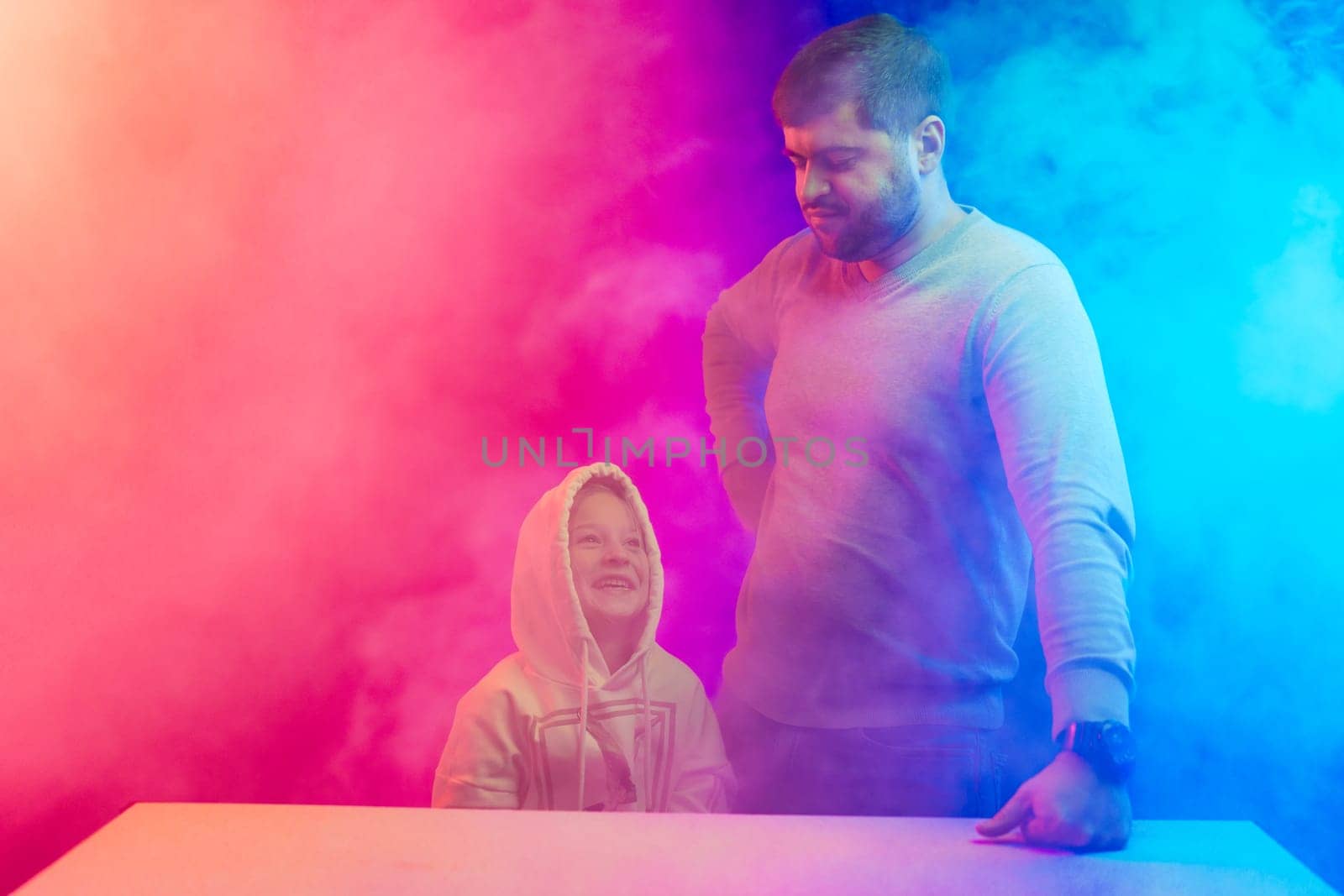 A little girl with her dad stands in the colored smoke by Fabrikasimf