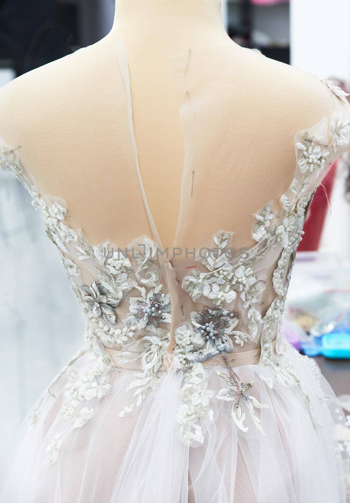 Detail of a weddings dress on a mannequin