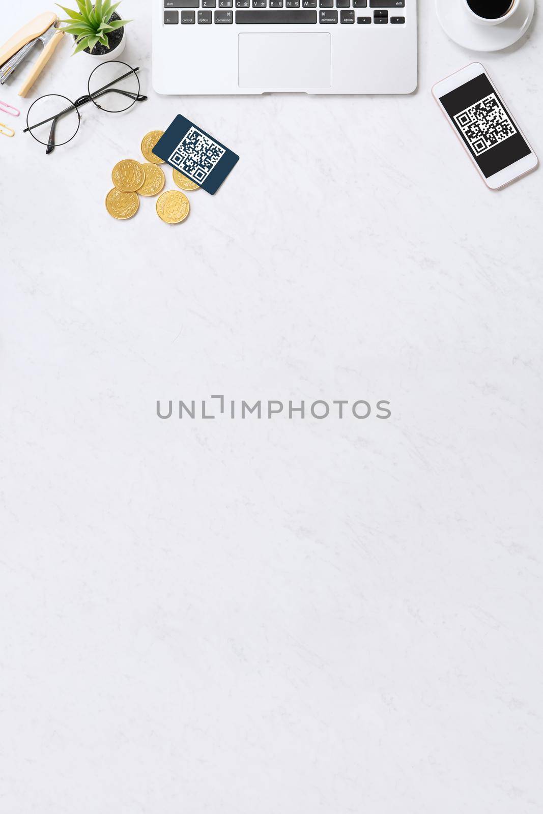 Online payment with QR code concept, virtual credit card, smart phone on office laptop desk on clean marble table background, top view, flat lay