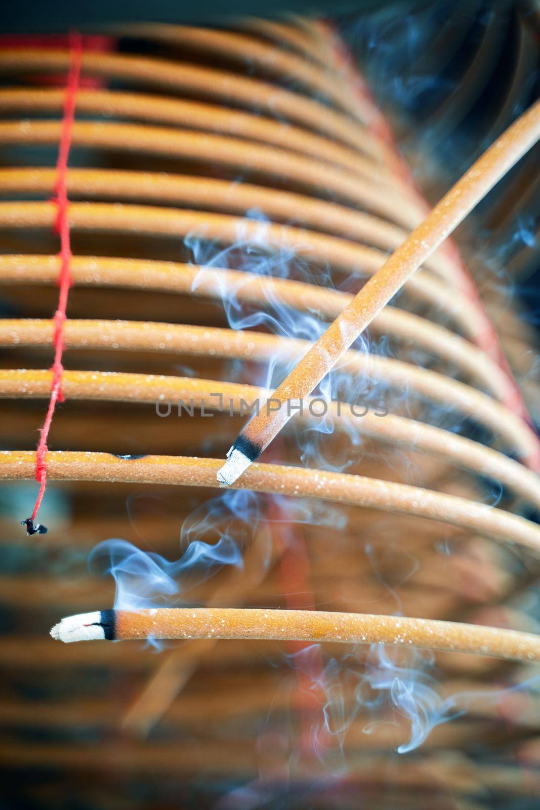 Burned coil swirl incense in Macau (Macao) temple, traditional Chinese cultural customs to worship god, close up, lifestyle.