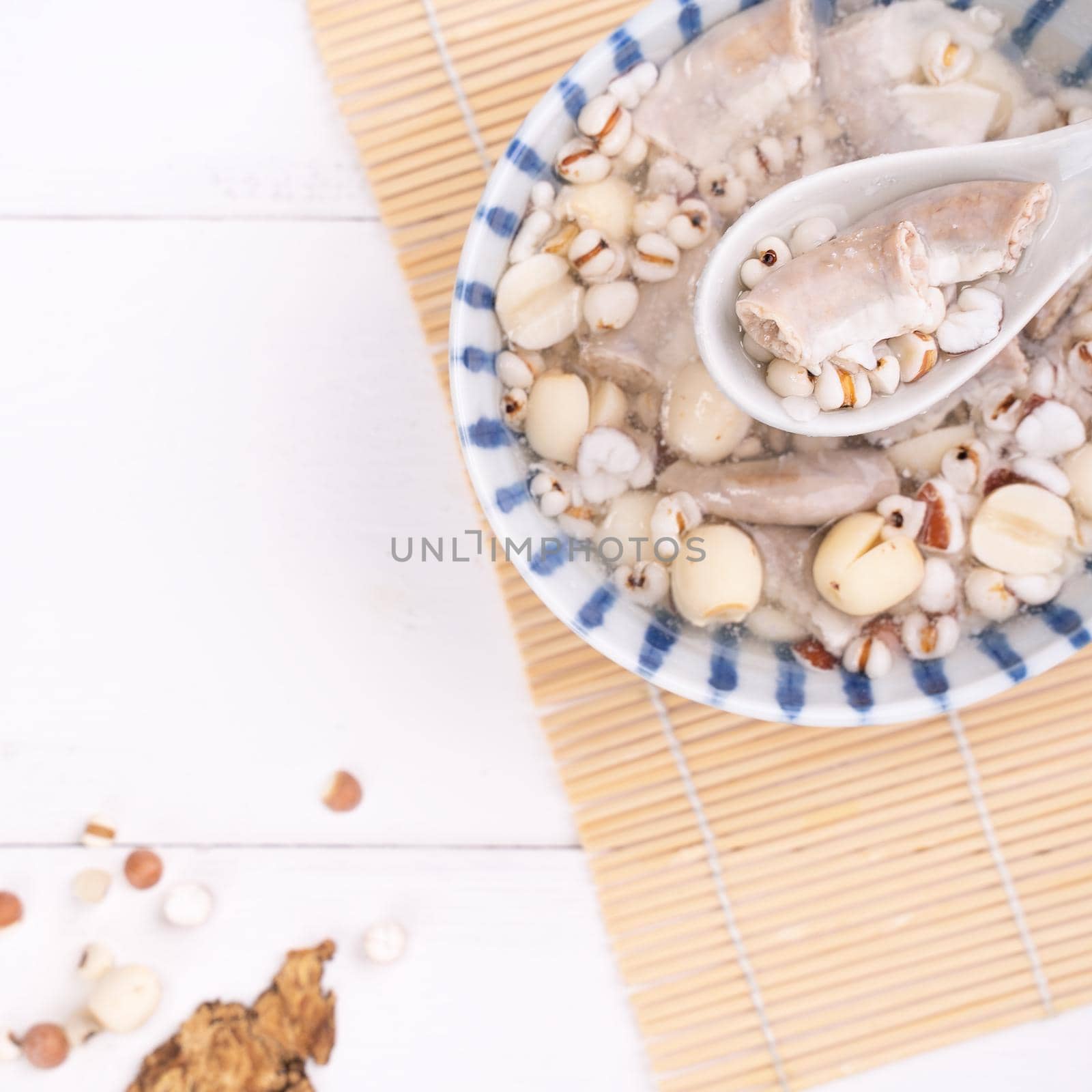 Tasty Four Tonics Herb Flavor Soup, Taiwanese traditional food with herbs, pork intestines on white wooden table, close up, flat lay, top view.