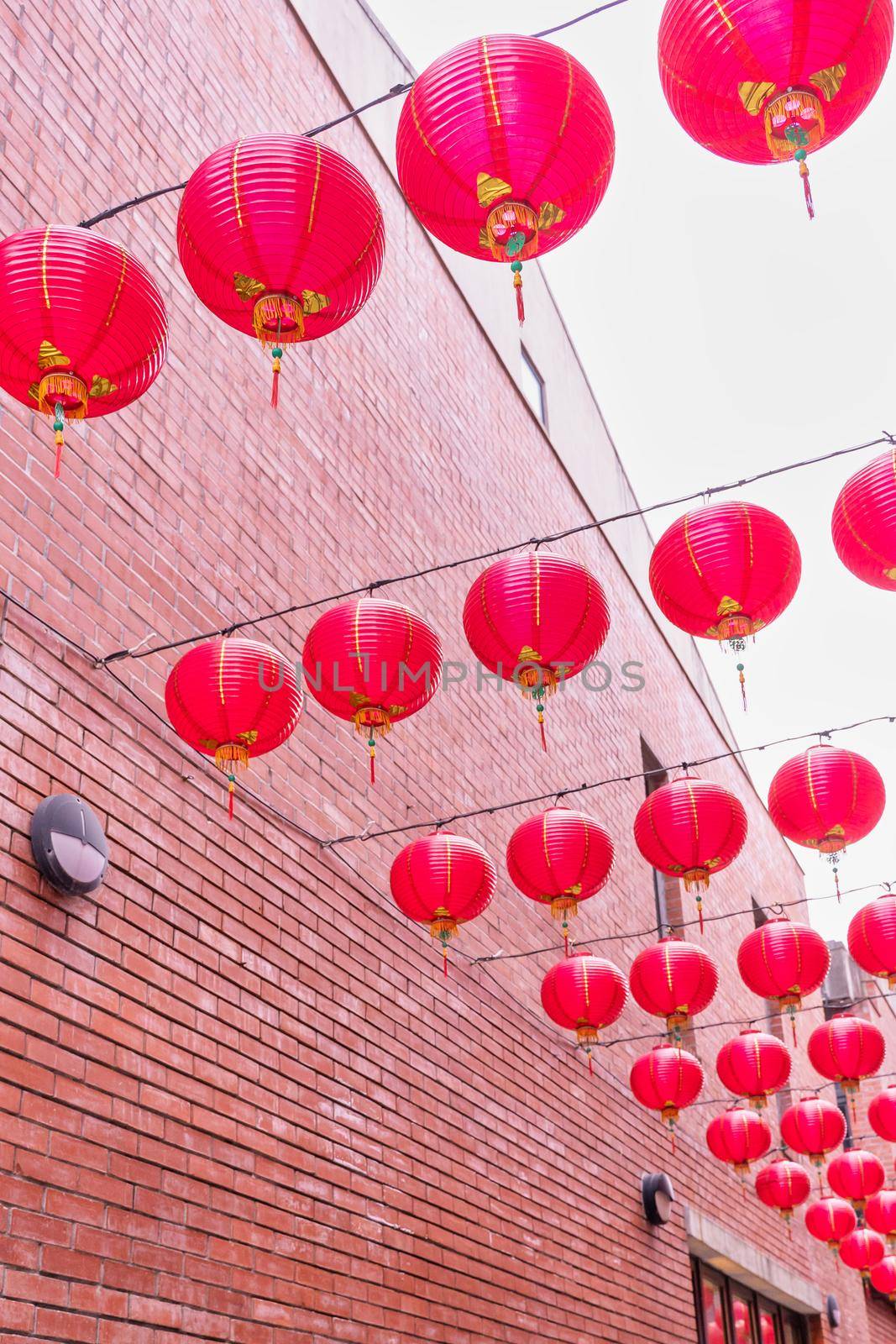 Beautiful round red lantern hanging on old traditional street, concept of Chinese lunar new year festival, close up. The undering word means blessing.